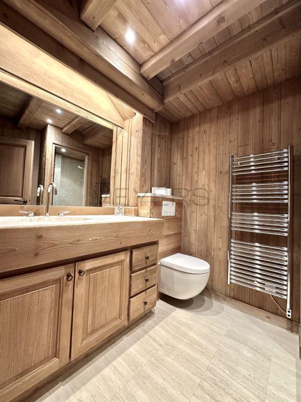Salle de bains d’un chalet à Megève Salle de bains en bois avec lavabo et toilettes dans un chalet à Megève.