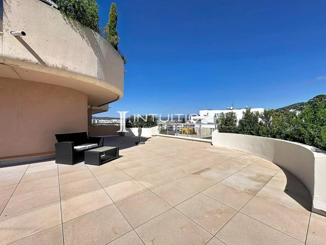 Spacious terrace of an apartment in Cannes, with modern furniture and unobstructed views.