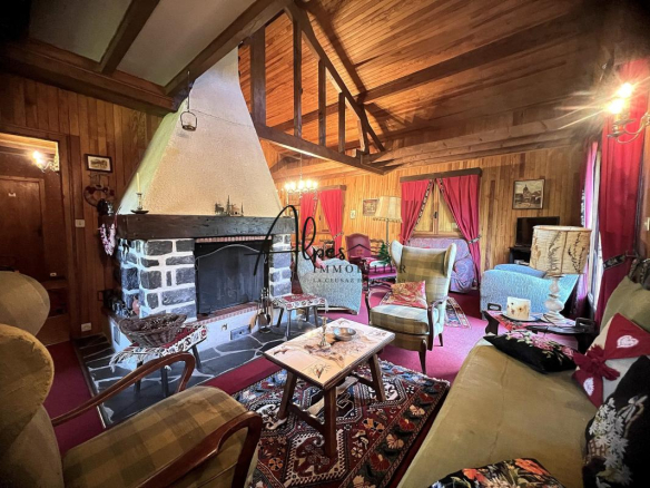 Interior of a wooden chalet with fireplace, comfortable living room and warm decor.