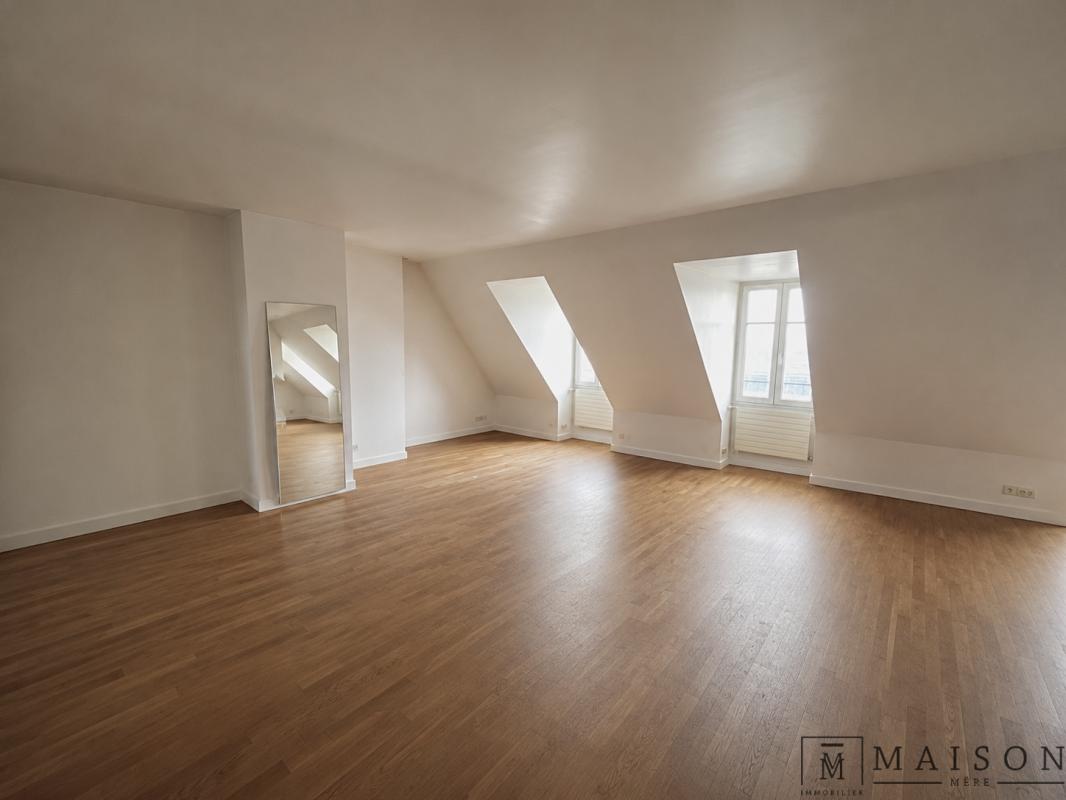 Appartement au dernier étage à Odéon Intérieur d'un appartement au dernier étage avec parquet et fenêtres, vue dégagée sur Paris.