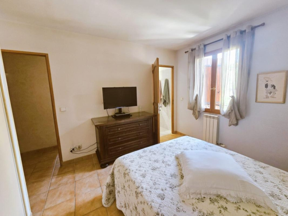 Room in a villa in Le Cannet with bed, television and window.