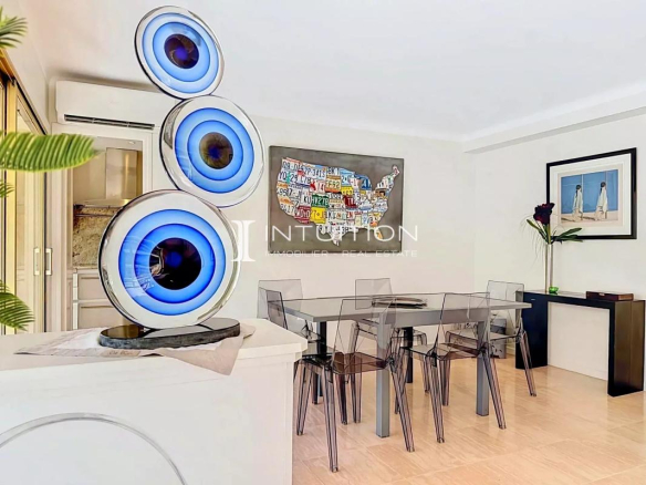 Interior of a modern apartment with a dining table and contemporary decor.