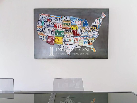 Map of the United States made with license plates, hanging on the wall of an apartment.