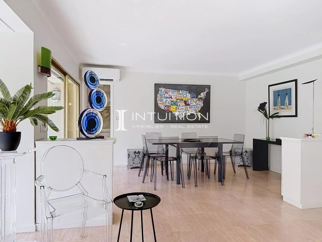 Bright apartment in Cannes Interior of a bright apartment with dining room and modern decor.
