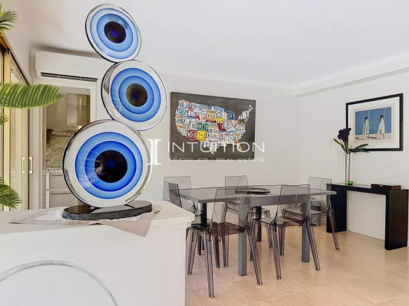 Interior of a modern apartment with a dining table and artistic decorations.