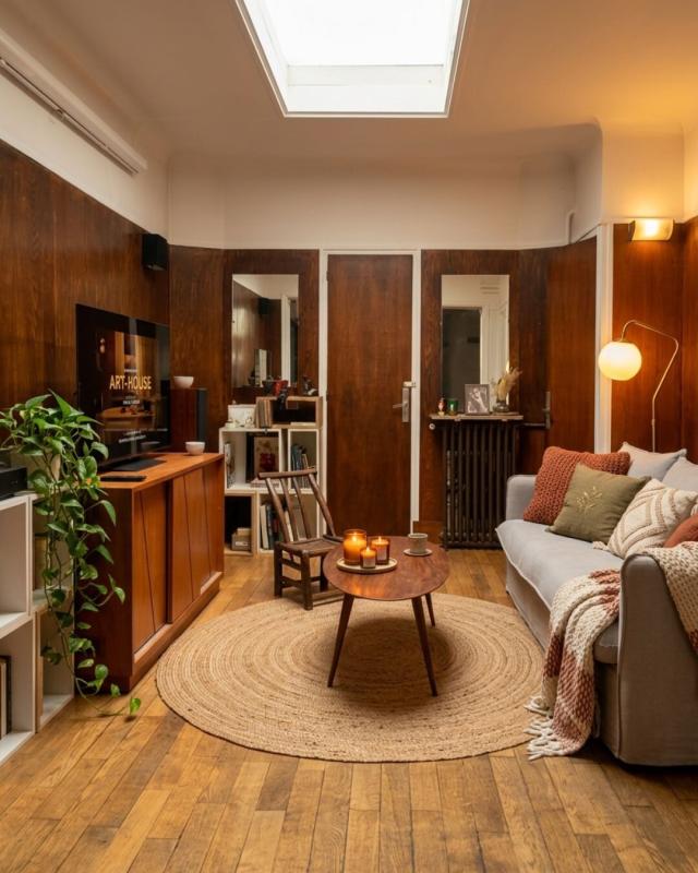 Living room of a house in Paris Interior of a house in Paris with a cozy living room, sofa, coffee table and television.