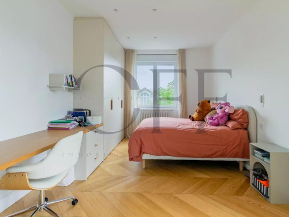 Bedroom in a penthouse in Neuilly-sur-Seine with bed, desk and toys.