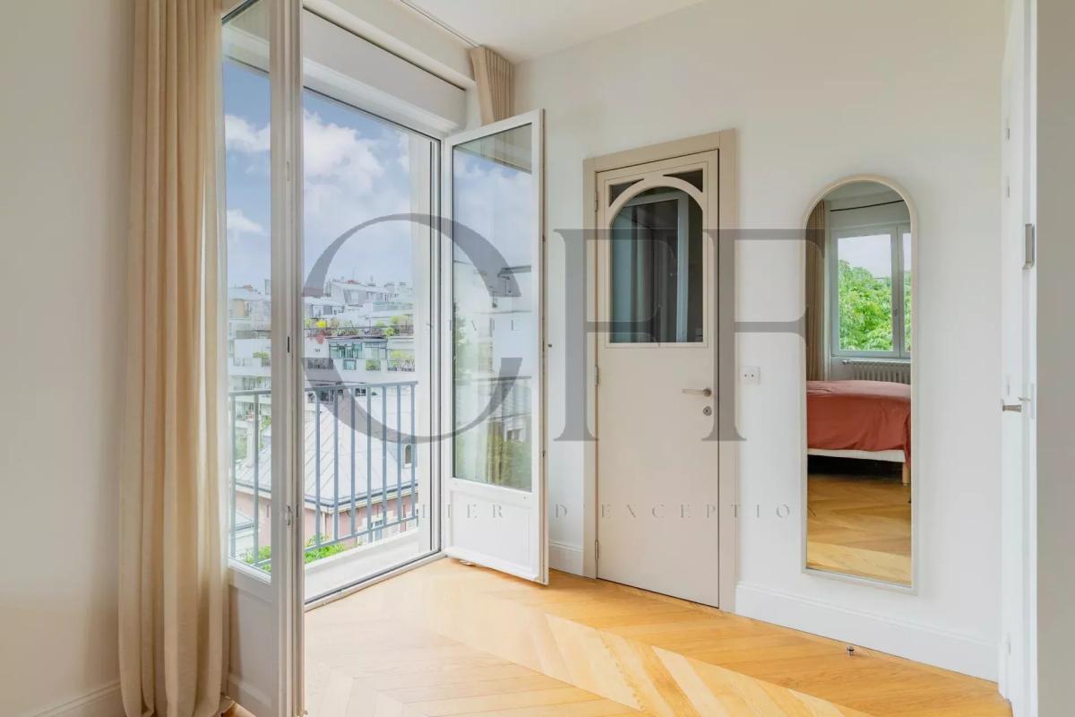 Interior of a penthouse in Neuilly-sur-Seine Interior of a penthouse in Neuilly-sur-Seine with open windows and wooden parquet flooring.