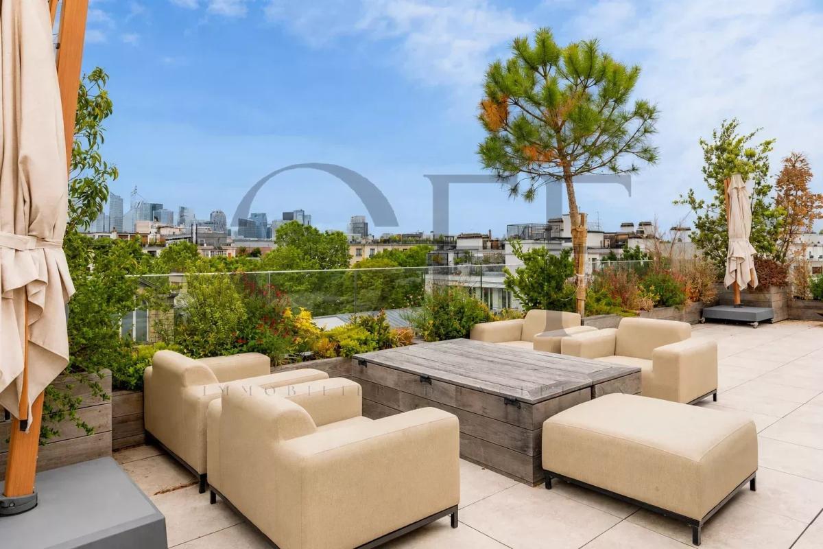 Terrace of a penthouse in Neuilly-sur-Seine Landscaped terrace of a penthouse in Neuilly-sur-Seine with modern furniture and city view.