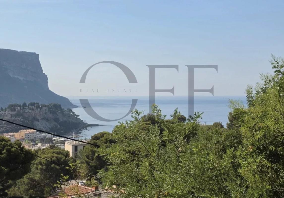 Sea view in Cassis Panoramic view of the sea and hills from Cassis, with trees in the foreground.