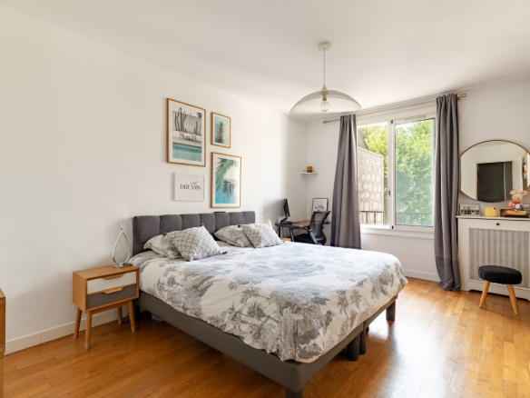 Chambre d'un appartement à Paris avec lit double et décoration moderne.