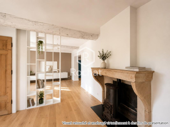 Intérieur d'une maison rénovée avec cheminée et étagères modernes.