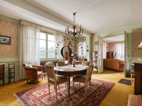 Intérieur d'une maison bourgeoise à Saint-Ouen-sur-Seine, avec mobilier ancien et tapis au sol.