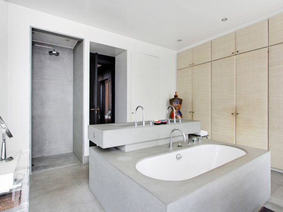 Modern bathroom with bathtub and shower in a private mansion in Paris.