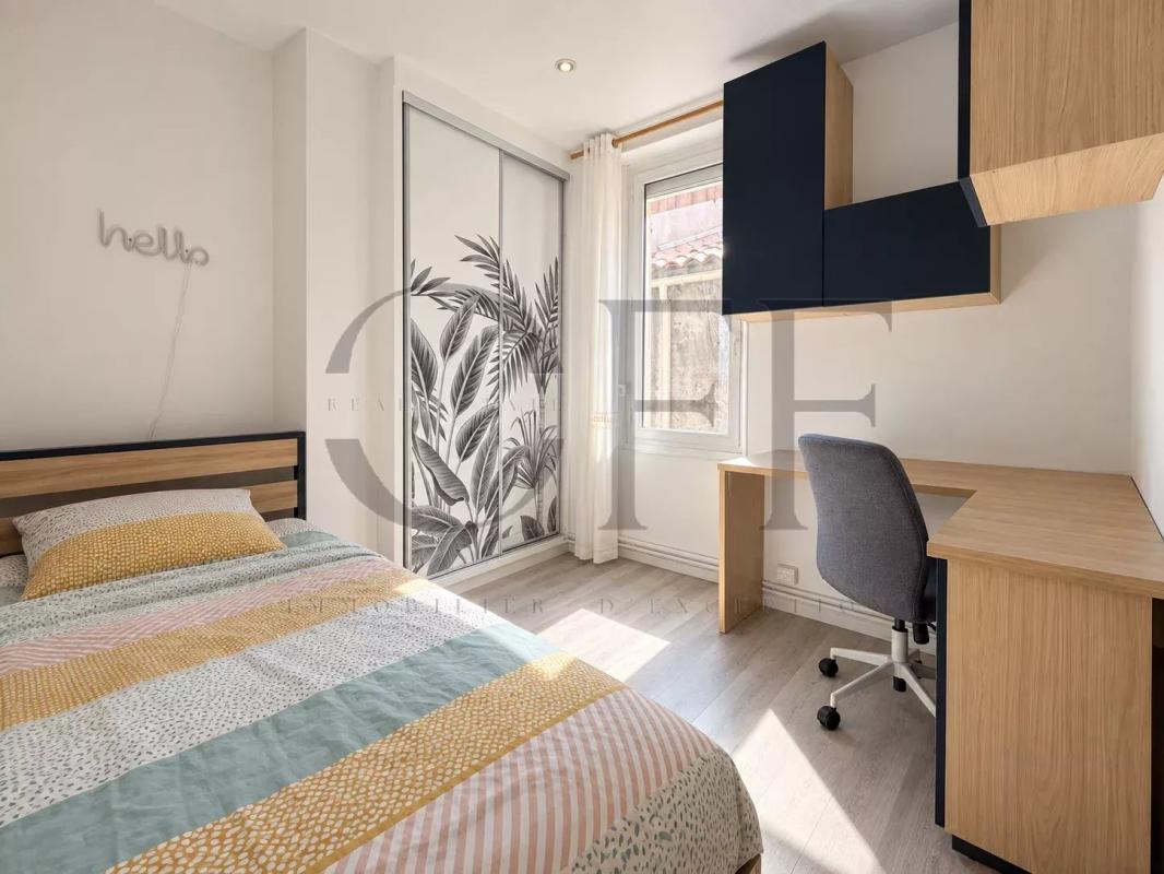 Modern room in Marseille Bedroom in a Marseille townhouse with bed, desk and modern decor.