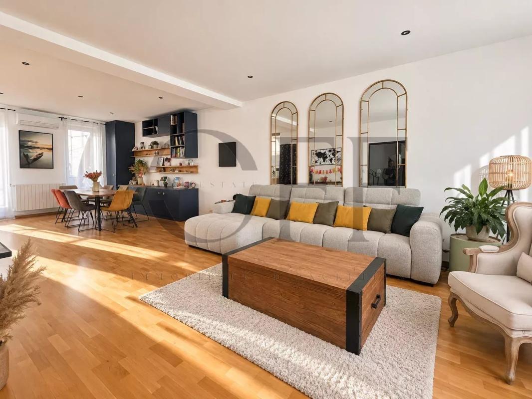 Living room of a townhouse in Marseille's 7th arrondissement Interior of a townhouse in Marseille 7th arrondissement, bright living room with sofa and dining table.
