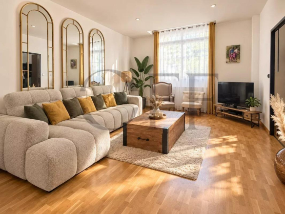 Interior of a townhouse in Marseille, bright living room with sofa and wooden coffee table.