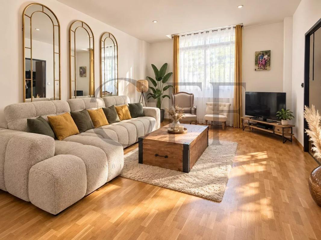 Living room of a townhouse in Marseille Interior of a townhouse in Marseille, bright living room with sofa and wooden coffee table.