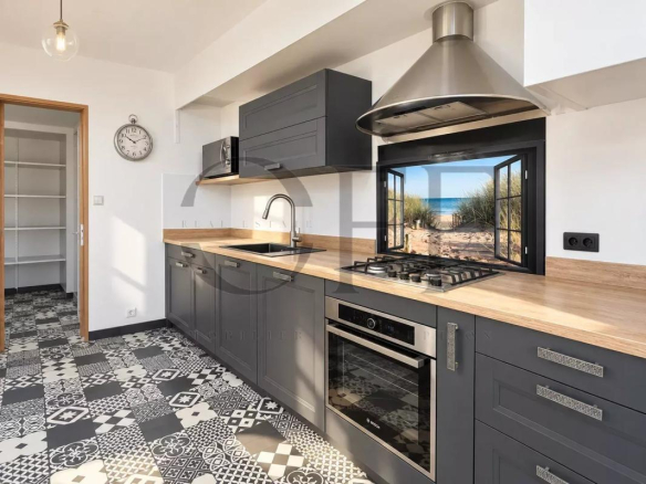 Modern kitchen with grey cabinets and decorative tiles
