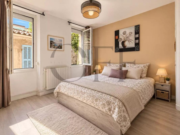 Room in a townhouse in Marseille, with a double bed and open windows.