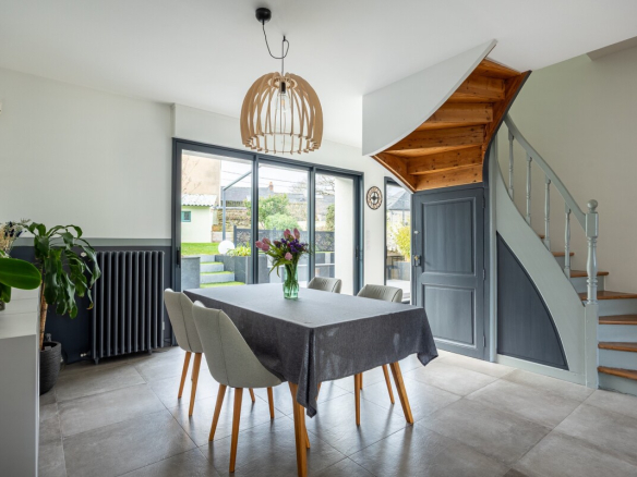 Interior of a house in Nantes with dining room, wooden staircase and natural light.