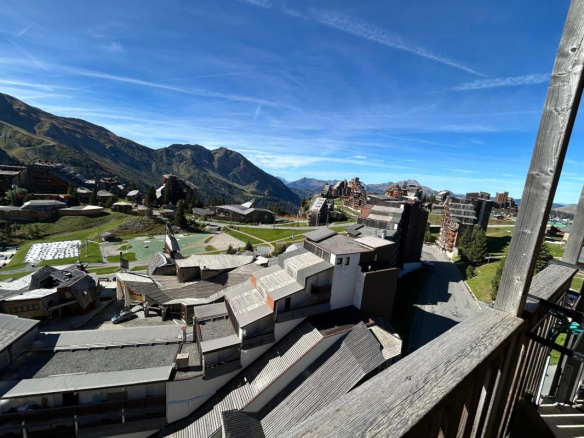 Panoramic view from a balcony of a duplex apartment in Avoriaz, with mountains in the background.