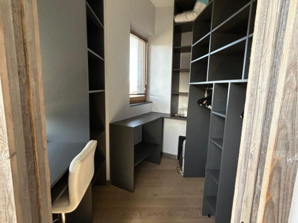Office furnished with shelves and desk in a duplex apartment in Morzine.