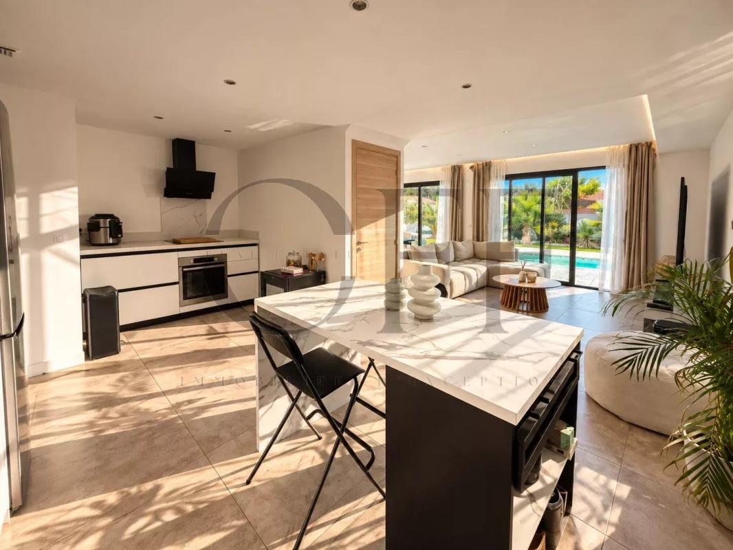 Interior of a contemporary villa Interior of a contemporary villa with open kitchen and bright living room, overlooking the pool.