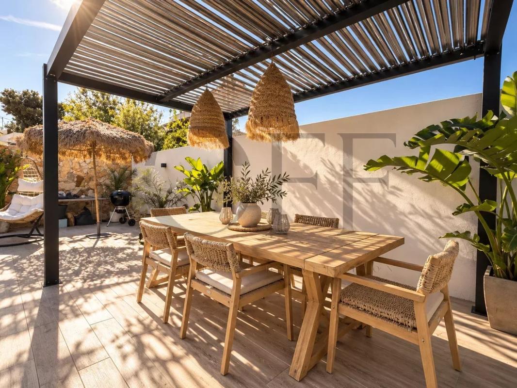 Terrace of a contemporary villa in Le Rove Outdoor terrace of a contemporary villa with wooden furniture and plants.