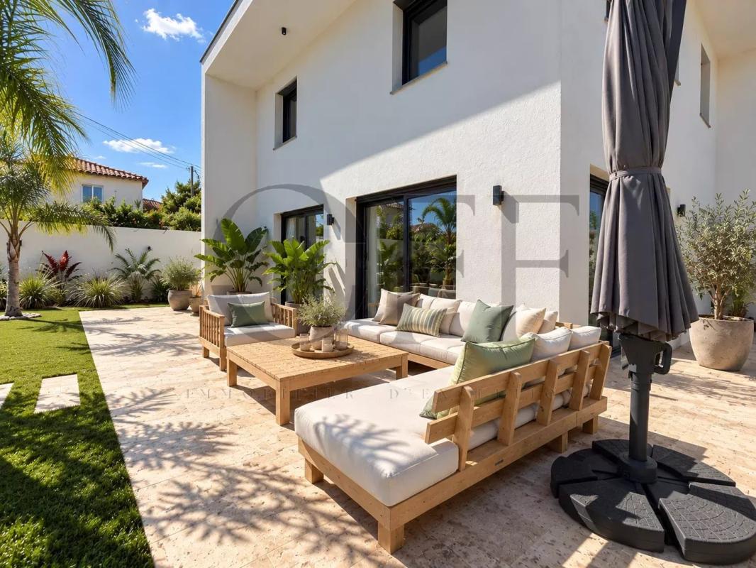 Terrace of a contemporary villa Terrace of a contemporary villa with wooden furniture and plants, Le Rove.