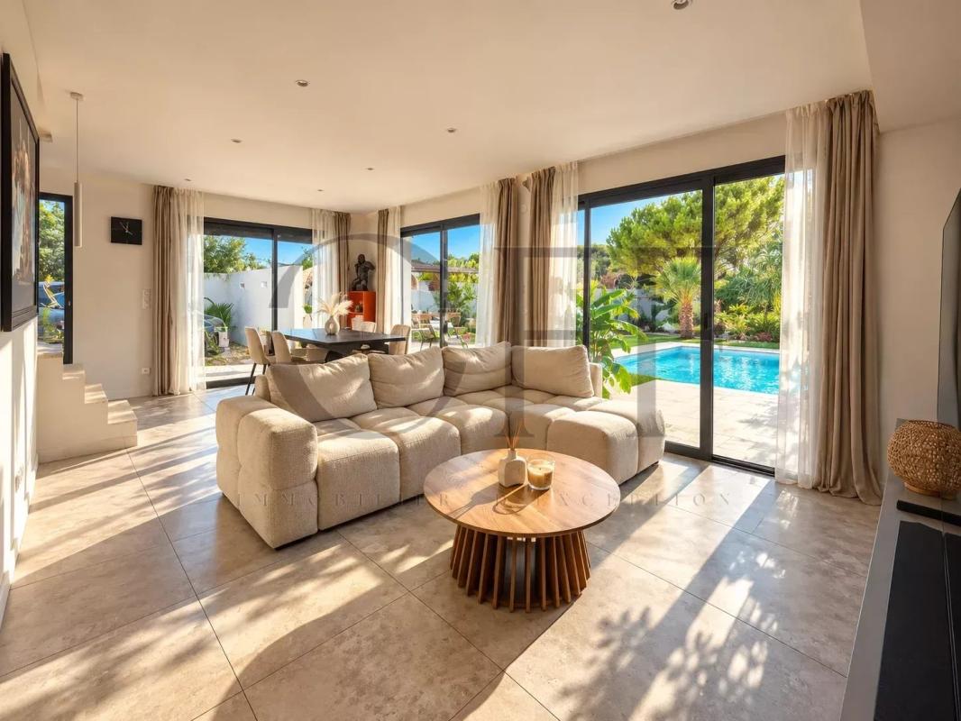 Interior of a contemporary villa in Le Rove Interior of a contemporary villa with a bright living room and outdoor swimming pool in Le Rove.