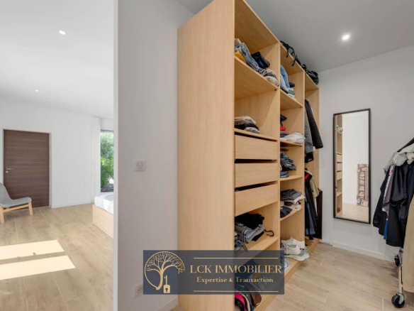 Intérieur d'une villa contemporaine avec un rangement en bois et un éclairage naturel.