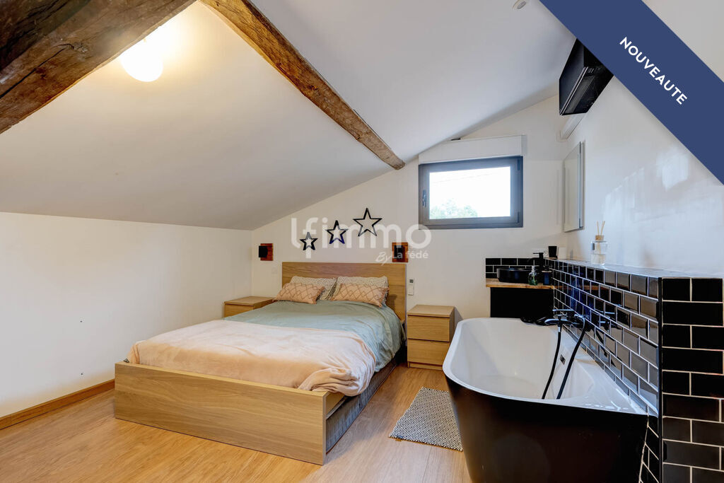 Modern room in a renovated property Room in a renovated property with bathtub, bed and modern decor.