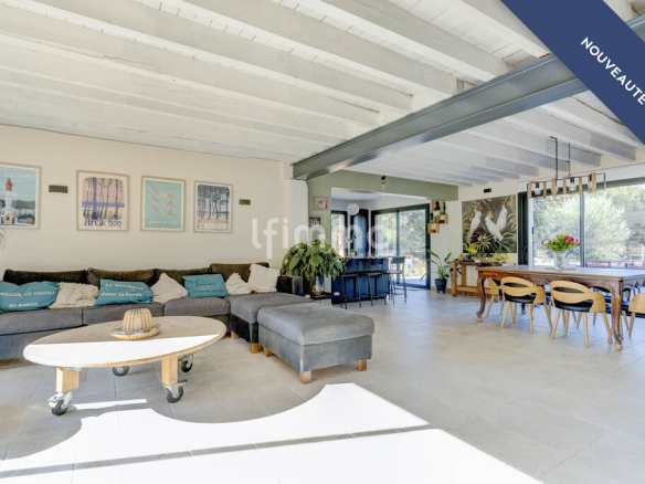 Interior of a renovated house with a spacious living room and a bright dining room.