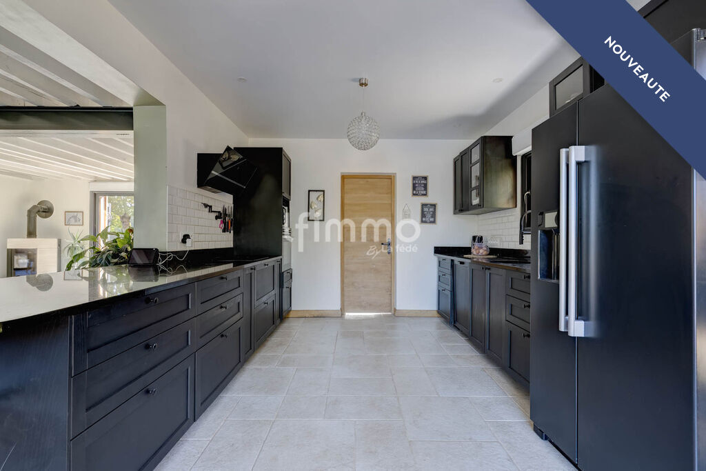 Modern kitchen in a renovated property Modern kitchen in a renovated house with black furniture and marble surfaces.