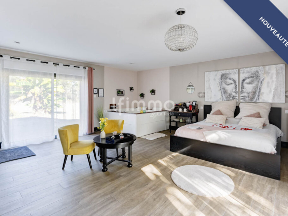 Modern room with king-size bed and minimalist decor in a renovated property.