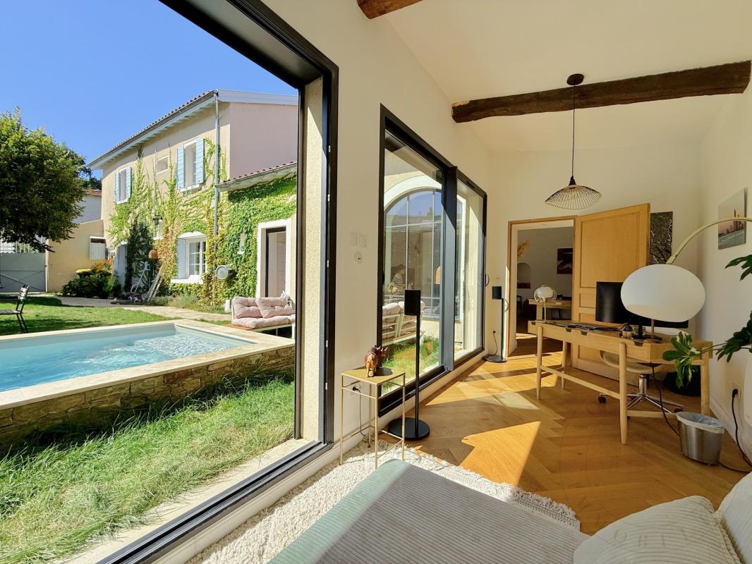 Demeure historique à Chaponost Intérieur d'une demeure historique rénovée avec vue sur le jardin et la piscine à Chaponost.