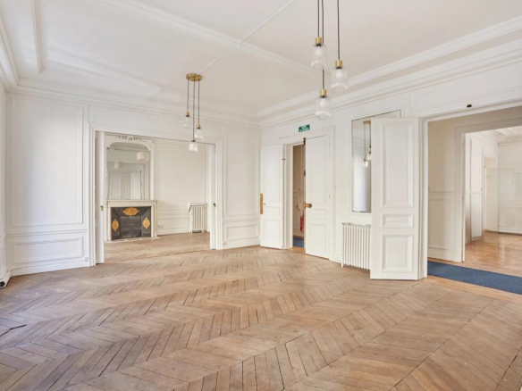 Intérieur d'un appartement de 200 m² à Paris, avec parquet en points de Hongrie et moulures.