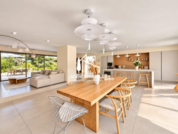 Intérieur d'une villa contemporaine à Nîmes avec cuisine ouverte et salle à manger lumineuse.