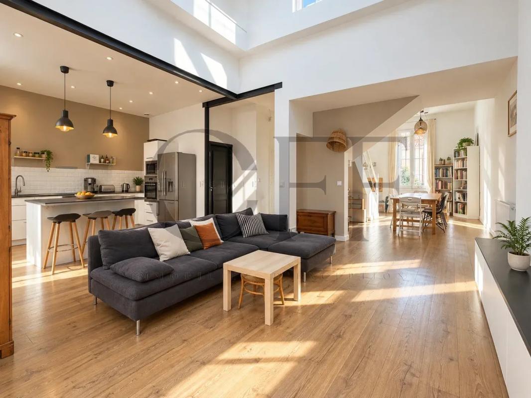 Maison de ville rénovée à Marseille Intérieur d'une maison de ville rénovée avec salon lumineux et cuisine ouverte.