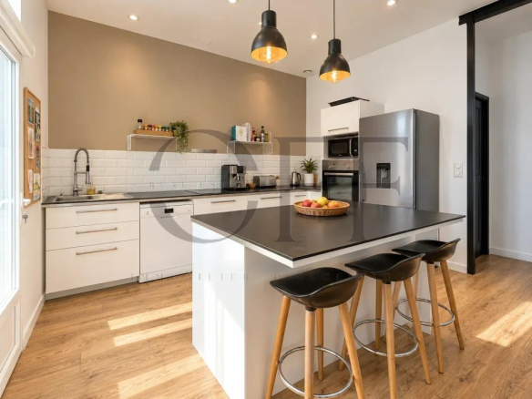 Cuisine moderne et lumineuse d'une maison de ville à Marseille, avec îlot central et équipements récents.