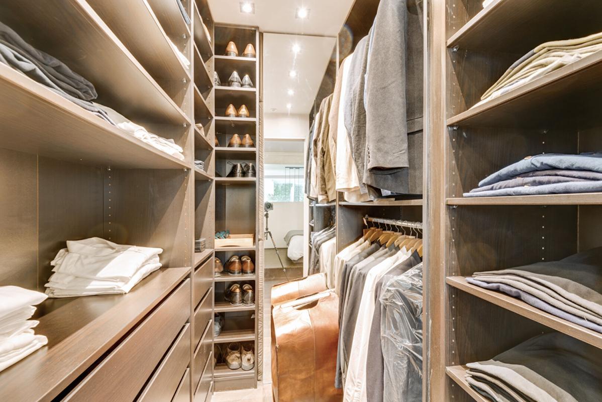 Dressing moderne Dressing spacieux avec étagères et vêtements bien organisés.