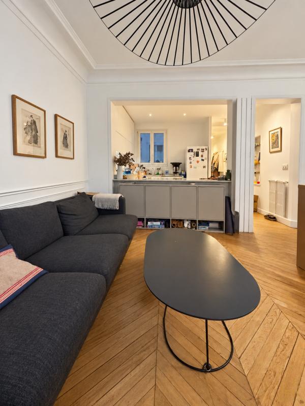 Haussmannian apartment in Paris 9 Interior of a Haussmannian apartment in Paris 9, with a bright living room and a kitchen area.