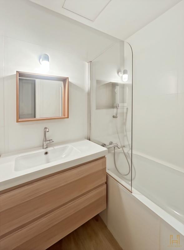 Modern bathroom Modern bathroom with bathtub, sink and wooden mirror.