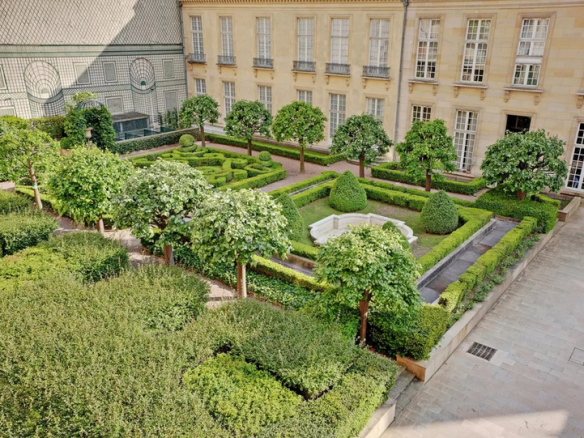 Unobstructed view of gardens with trees and hedges in a residence in Paris