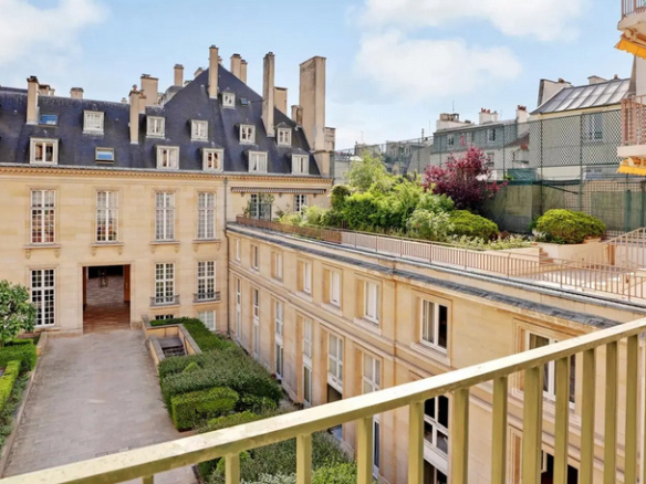 Unobstructed view of gardens from an apartment balcony in the Marais, Paris 3rd arrondissement.