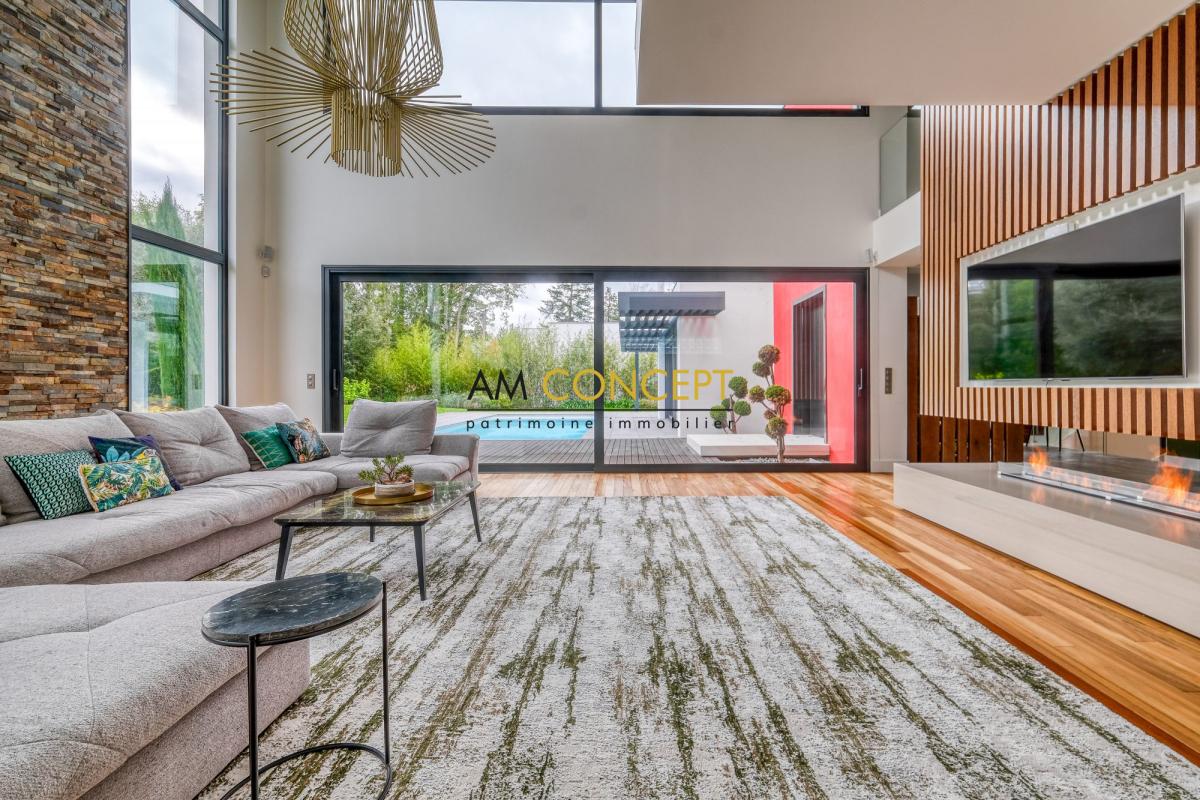 Salon d’une maison d’architecte à Chessy Intérieur d'une maison d'architecte moderne avec un salon lumineux et une décoration contemporaine.