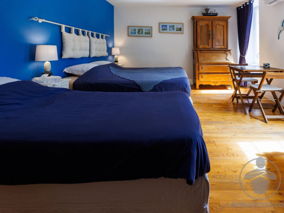Guest room with two beds and wooden furniture in a property with character.