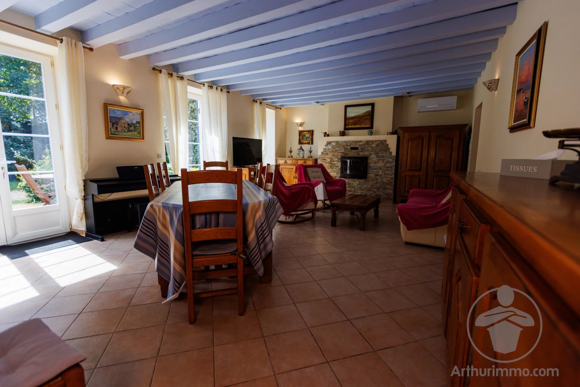 Interior of a house in the Landes region Interior of a Landes-style house with dining room and living room, natural light