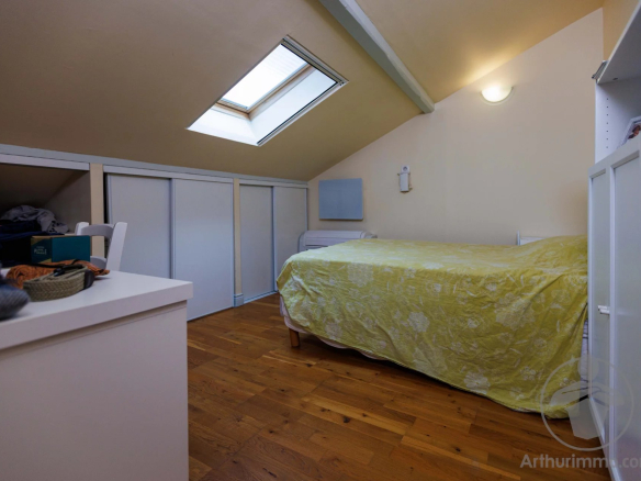 Attic room with bed and storage in a character property in Liposthey.